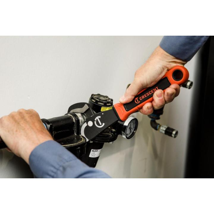 Image of the 12" Self-Adjusting Dual Material Pipe Wrench with a person using the wrench on a pipe